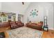 Spacious living room with hardwood floors, comfortable sofas, and an area rug at 15 Cole Creek Way, Franklinton, NC 27525