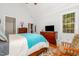 Bright main bedroom with hardwood floors, crown molding and a comfortable sitting area at 15 Cole Creek Way, Franklinton, NC 27525