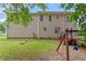 View of home's backyard featuring a swing set and well-maintained lawn, perfect for outdoor activities at 161 Jacob St, Holly Springs, NC 27540
