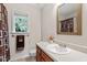 Neutral bathroom featuring a white sink, toilet, and a shower with a decorative shower curtain at 161 Jacob St, Holly Springs, NC 27540