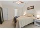 Neutral bedroom featuring a queen-sized bed, white nightstand, and natural lighting at 161 Jacob St, Holly Springs, NC 27540