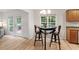 Cozy breakfast nook with a table set for two, illuminated by natural light from the surrounding windows at 161 Jacob St, Holly Springs, NC 27540