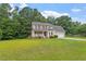 Inviting two-story home with a charming front porch, well-manicured lawn, and attached garage at 161 Jacob St, Holly Springs, NC 27540