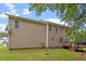 Home exterior with a well-kept lawn and a wooden deck, showcasing the backyard amenities at 161 Jacob St, Holly Springs, NC 27540
