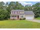 Inviting two-story home with a lush green lawn and attached two car garage at 161 Jacob St, Holly Springs, NC 27540