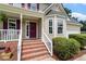 Charming front porch with brick steps and decorative shrubbery at 161 Jacob St, Holly Springs, NC 27540