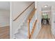 Hallway with stairs leading to the upper level, next to formal dining room at 161 Jacob St, Holly Springs, NC 27540