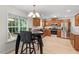 Bright kitchen area featuring stainless steel appliances, wood cabinets, an eat-in dining area, and backyard views at 161 Jacob St, Holly Springs, NC 27540