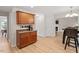 Open-concept kitchen with wood cabinets and dining area, flowing into a living space with a fireplace at 161 Jacob St, Holly Springs, NC 27540