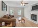 Cozy living room with hardwood floors, a fireplace, and natural light at 161 Jacob St, Holly Springs, NC 27540