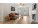 Comfortable living room with hardwood floors, fireplace, and large picture window at 161 Jacob St, Holly Springs, NC 27540