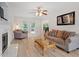 Bright living room with a fireplace, hardwood floors, and access to the backyard at 161 Jacob St, Holly Springs, NC 27540