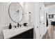 Chic bathroom featuring sleek black fixtures, granite countertop and stylish round mirror at 1626 Plover Cir, Fuquay Varina, NC 27526