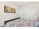 Cozy bedroom with a bed featuring patterned bedding and two picturesque paintings on the wall at 1626 Plover Cir, Fuquay Varina, NC 27526