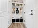 Bright mudroom with built in storage compartments, coat hooks, shelving, and modern flooring at 1626 Plover Cir, Fuquay Varina, NC 27526