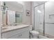 Clean bathroom with a shower, white vanity, granite countertop, and neutral tiling at 1633 Hillstar St, Fuquay Varina, NC 27526