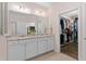 Bathroom with double vanity, granite counters, and an open walk-in closet at 1633 Hillstar St, Fuquay Varina, NC 27526