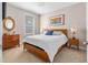 Cozy bedroom with wood furniture, neutral walls, and natural light from the window at 1633 Hillstar St, Fuquay Varina, NC 27526