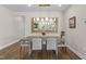 Dining room with wood floors, stylish lighting, mirror, and seating for six at 1633 Hillstar St, Fuquay Varina, NC 27526
