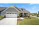 Charming single-Gathering home with a two-car garage, manicured lawn and inviting front porch at 1633 Hillstar St, Fuquay Varina, NC 27526