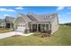 A charming home featuring a two-car garage, inviting front porch, and lush landscaping at 1633 Hillstar St, Fuquay Varina, NC 27526