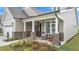 Inviting front porch with brick columns and charming seating area, perfect for relaxing at 1633 Hillstar St, Fuquay Varina, NC 27526