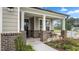 Cozy front porch with brick accents and comfortable seating, enhancing the home's curb appeal at 1633 Hillstar St, Fuquay Varina, NC 27526