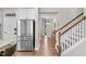 Hallway with wood flooring, staircase, and stainless steel refrigerator at 1633 Hillstar St, Fuquay Varina, NC 27526