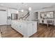 Bright, open-concept kitchen with an island, stainless steel appliances, and a view into the dining area at 1633 Hillstar St, Fuquay Varina, NC 27526