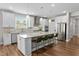 Modern kitchen with white cabinetry, stainless steel appliances, and a central island with bar seating at 1633 Hillstar St, Fuquay Varina, NC 27526