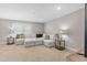 Bright living room featuring a plush couch, carpet, and recessed lighting at 1633 Hillstar St, Fuquay Varina, NC 27526