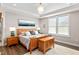 Main bedroom features a trey ceiling, natural lighting, and luxury furnishing at 1633 Hillstar St, Fuquay Varina, NC 27526