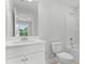 Clean bathroom with white cabinets, quartz countertop, modern fixtures, and a toilet at 1921 Fishamble St # 13, Fuquay Varina, NC 27526