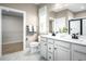 Well-lit bathroom with a double vanity, modern fixtures, and a walk-in closet at 196 Glen Hollow Dr, Raleigh, NC 27604