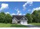 Charming single-story home with a brick facade, two-car garage, and a well-manicured front yard at 196 Glen Hollow Dr, Raleigh, NC 27604
