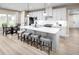 Bright kitchen featuring an island with barstool seating, stainless steel appliances, and a dining area at 196 Glen Hollow Dr, Raleigh, NC 27604