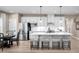 Bright kitchen featuring an island with barstool seating, stainless steel appliances, and a dining area at 196 Glen Hollow Dr, Raleigh, NC 27604