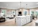 Open-concept living space with modern kitchen, featuring a spacious seating area with ample natural light at 196 Glen Hollow Dr, Raleigh, NC 27604