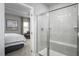 Modern bathroom with a tiled shower, a glass door, and a view of the bedroom at 197 Glen Hollow Dr, Raleigh, NC 27604