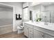 Bright bathroom featuring a double vanity, a window, and a view of the walk-in closet at 197 Glen Hollow Dr, Raleigh, NC 27604