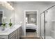 Clean bathroom featuring a double vanity, tile flooring, and a view to a bedroom at 197 Glen Hollow Dr, Raleigh, NC 27604