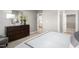 Bright bedroom with a dresser, a chair, and views into the kitchen and walk-in closet at 197 Glen Hollow Dr, Raleigh, NC 27604