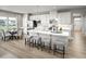 Bright kitchen featuring white cabinetry, stainless steel appliances, an island and a dining table at 197 Glen Hollow Dr, Raleigh, NC 27604