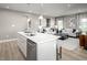 Open-concept kitchen with island seating flows into living area with stylish furnishings and decor at 197 Glen Hollow Dr, Raleigh, NC 27604