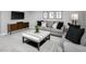 Comfortable living room with gray seating and stylish ottoman at 197 Glen Hollow Dr, Raleigh, NC 27604