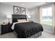 Inviting bedroom with a large window and dark-toned furnishings at 197 Glen Hollow Dr, Raleigh, NC 27604