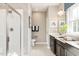 Clean bathroom with glass shower, beige walls, and wood cabinets with double sinks at 198 Glen Hollow Dr, Raleigh, NC 27604