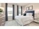 A bedroom featuring a queen bed with a white quilt and a navy headboard, along with curtains that match at 198 Glen Hollow Dr, Raleigh, NC 27604