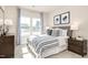 Bright bedroom with large windows, patterned curtains, and a gray upholstered headboard bed at 198 Glen Hollow Dr, Raleigh, NC 27604