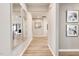 Bright hallway with wooden-style flooring and decorative mirrors on the wall at 198 Glen Hollow Dr, Raleigh, NC 27604